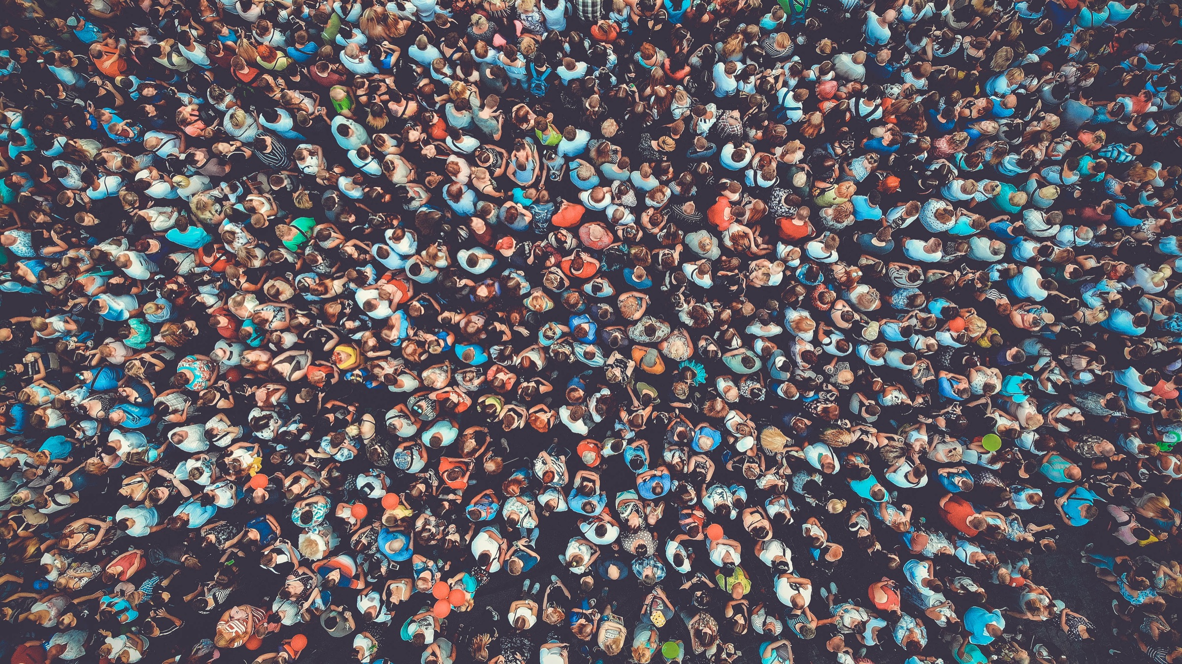 an aerial view of a festival crowd packed shoulder to shoulder